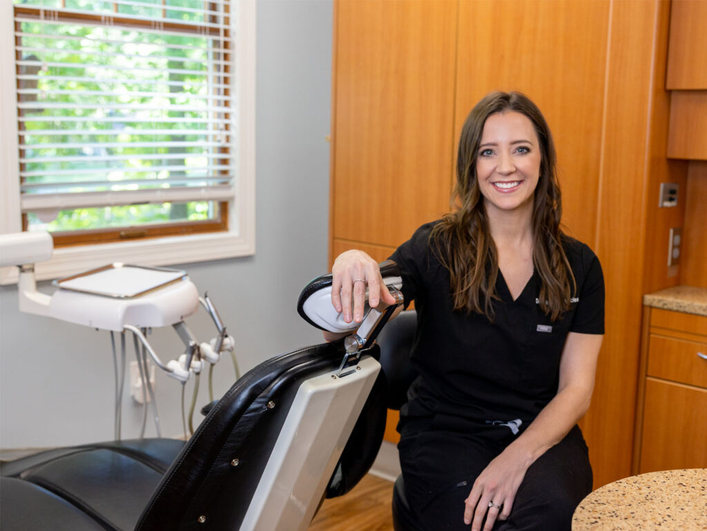 Dr. Eccles leaning on a dental chair